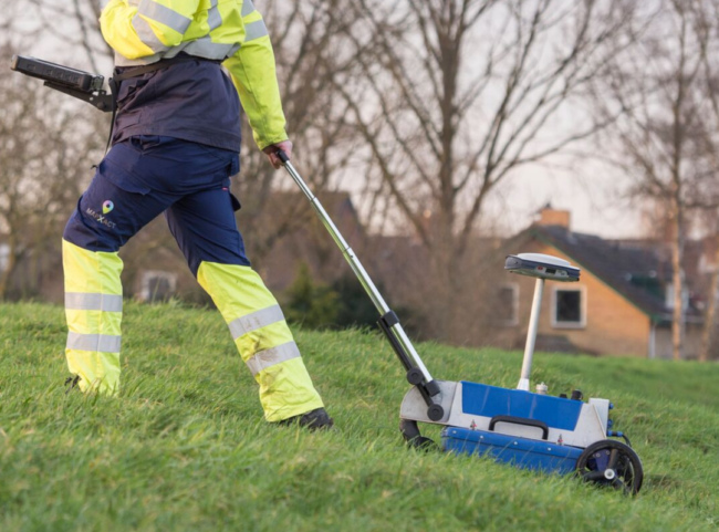 grondradar-mapxact Man loopt met grondradar in gras